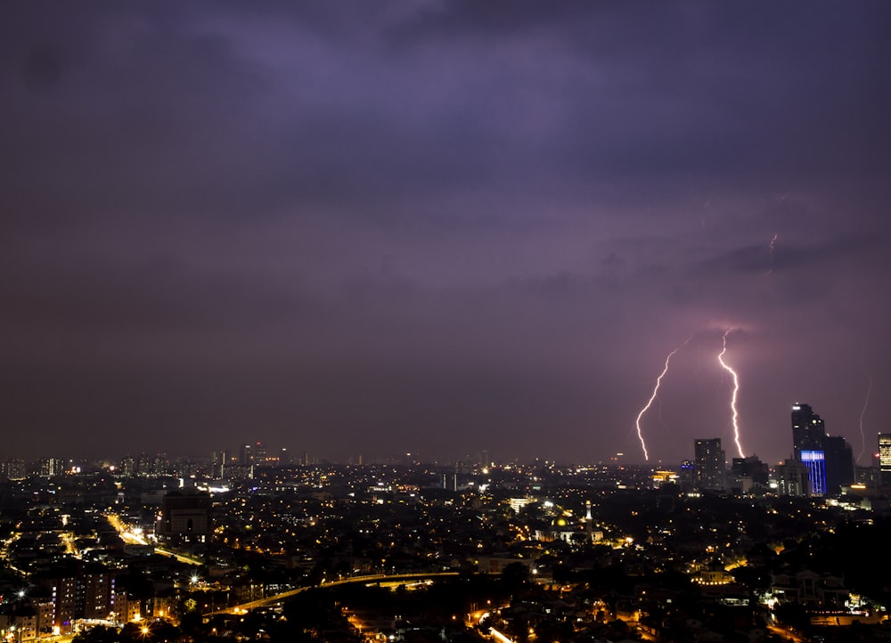 a view of a city at night with lightning