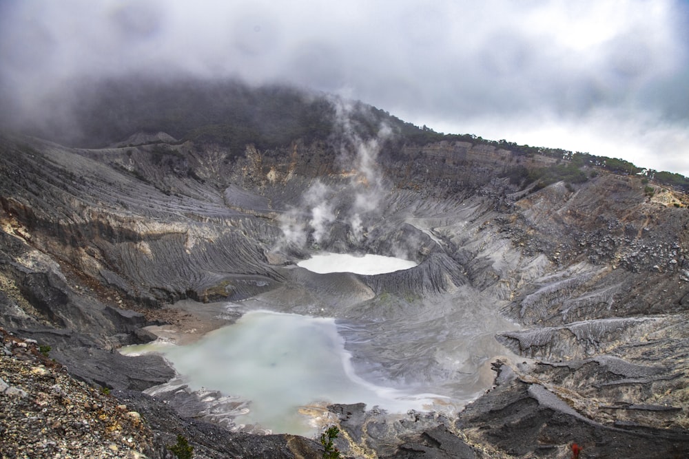 a large crater with a lake in the middle of it