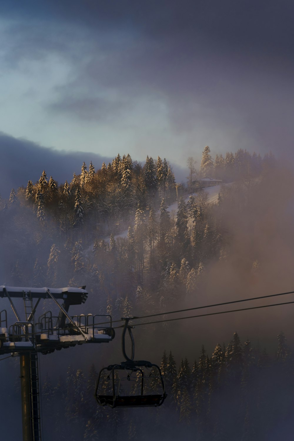 a ski lift with a mountain in the background