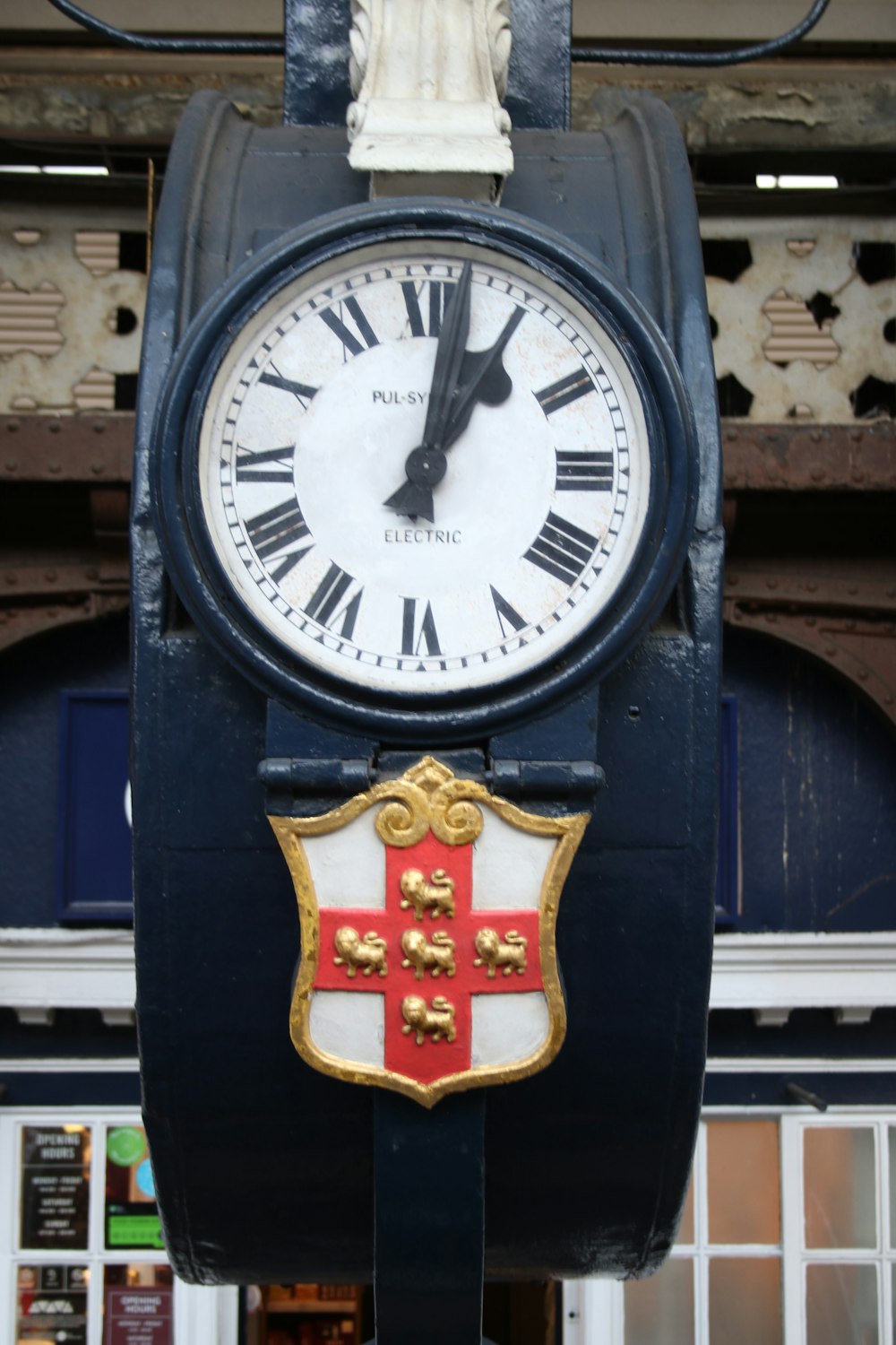 a clock with a coat of arms on it
