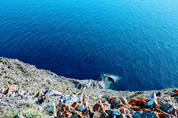 Clear water over a rocky shore, from the cliff above — Almería, Spain