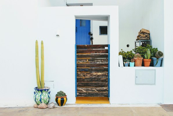 A whitewashed house with a blue door and cacti — Almería, Spain
