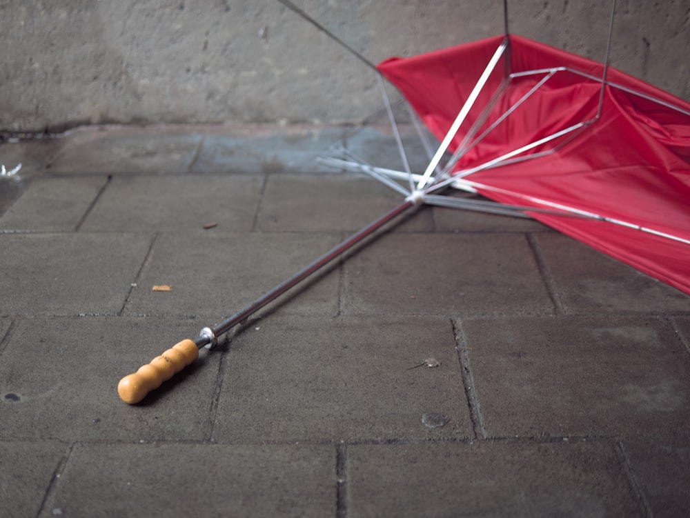 a red umbrella laying upside down on the ground