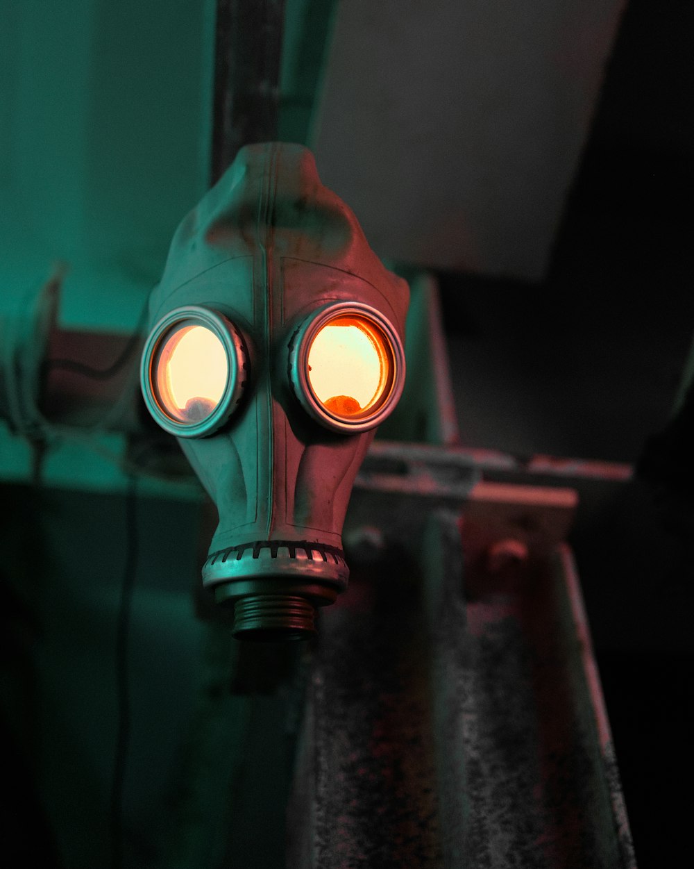 a gas mask with glowing eyes on a table