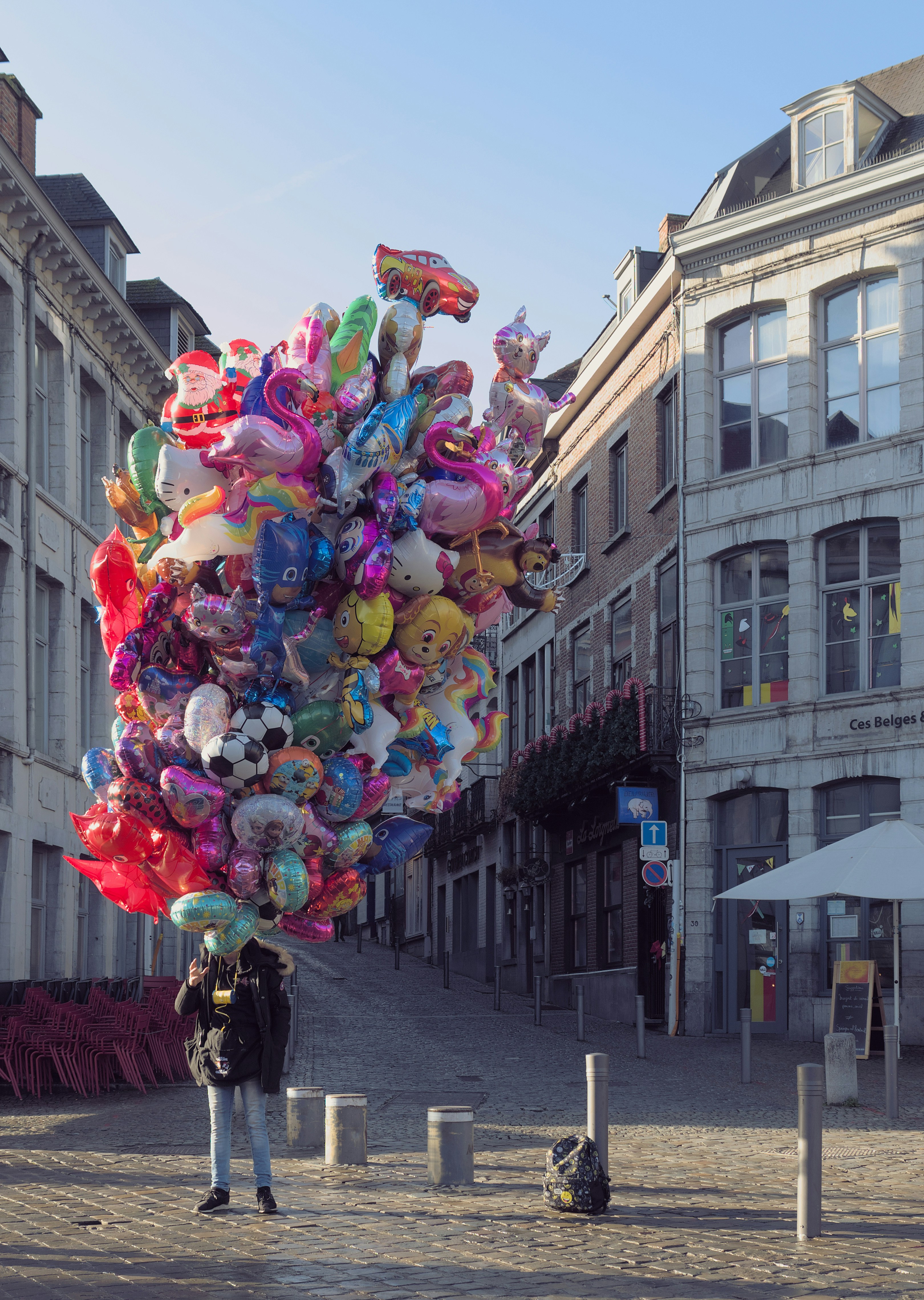 a man standing in front of a bunch of balloons