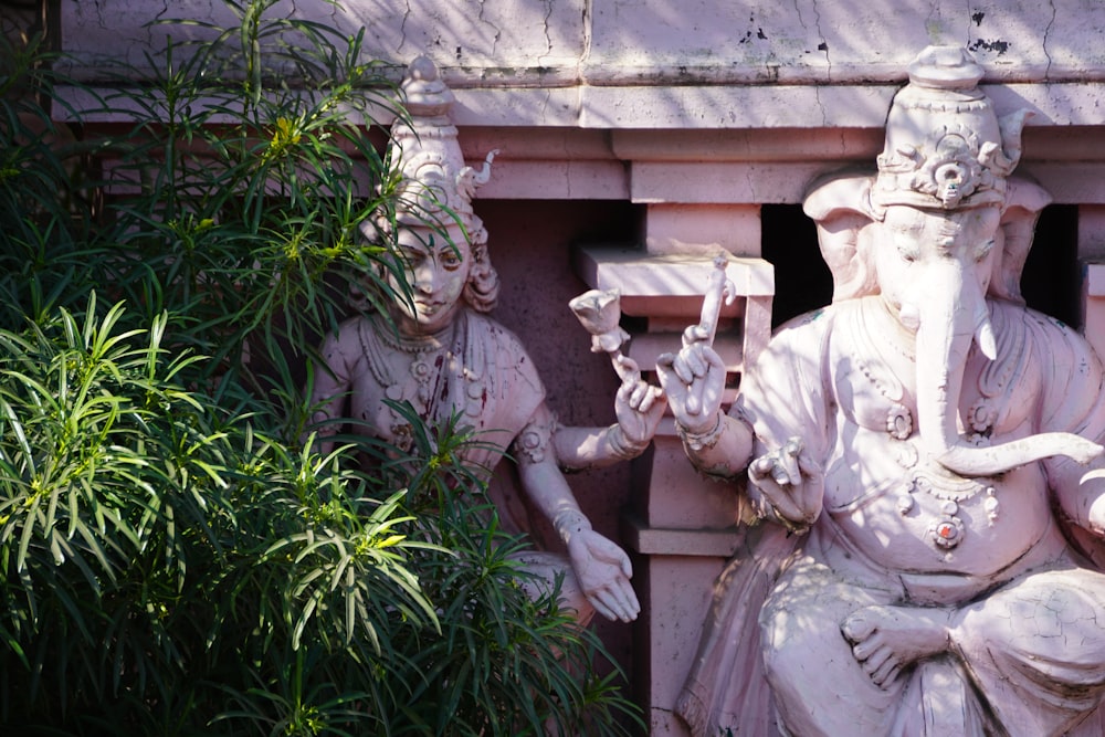 a statue of a man sitting on a bench