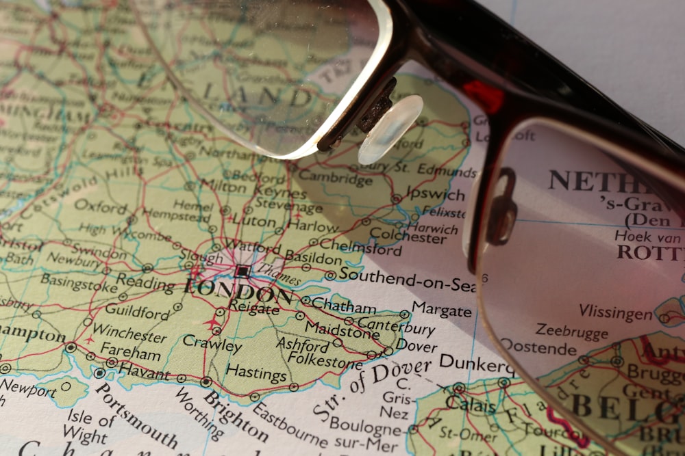 a pair of glasses sitting on top of a map