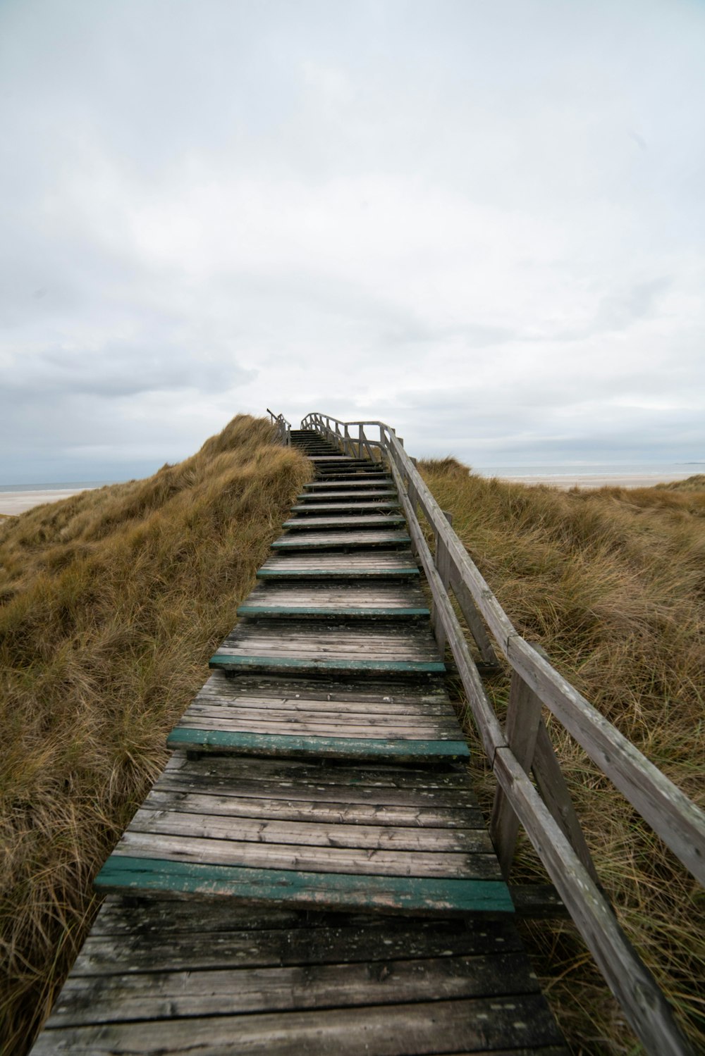 a set of wooden stairs leading to the top of a hill