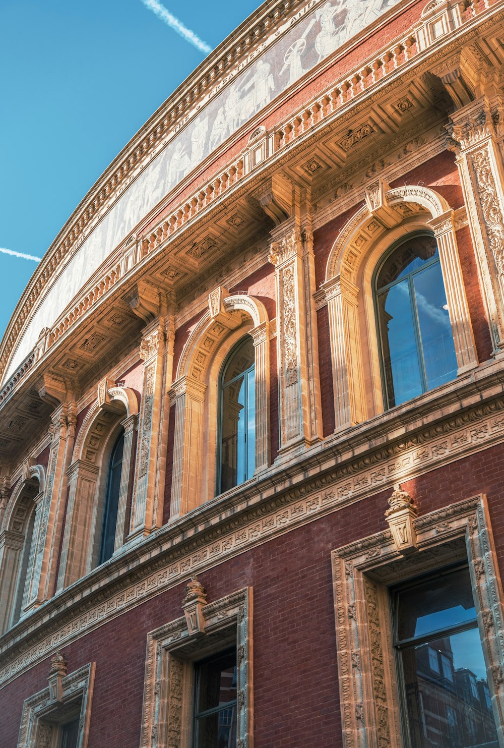 a red brick building with a plane in the sky