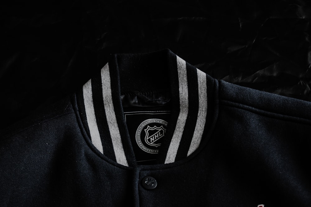 a close up of a black jacket with white stripes