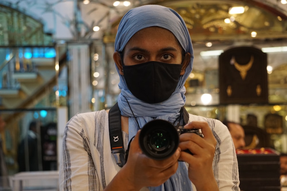 a woman taking a picture with a camera