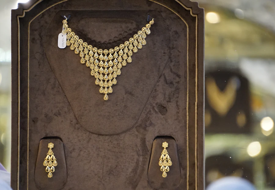 A gold necklace set in a jeweller’s display case