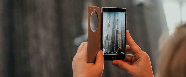 a woman taking a picture with her cell phone