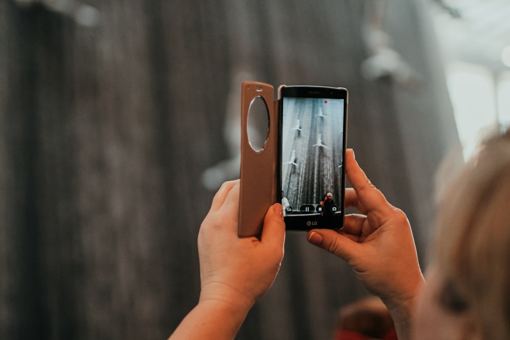 a woman taking a picture with her cell phone