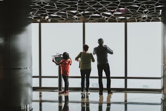 a group of people standing in front of a window