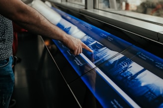 a man is pointing at a large poster