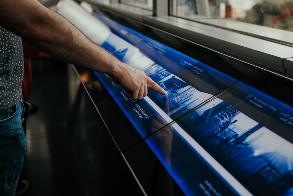 a man is pointing at a large poster