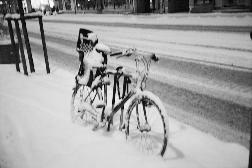 a bike parked on the side of the road covered in snow