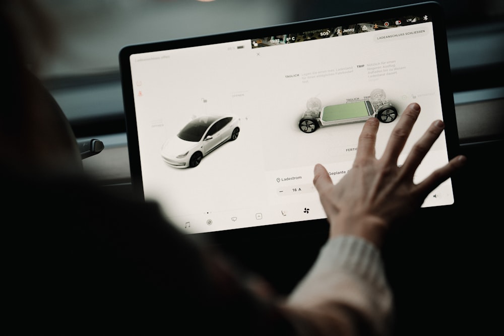 a person is looking at a computer screen with cars on it