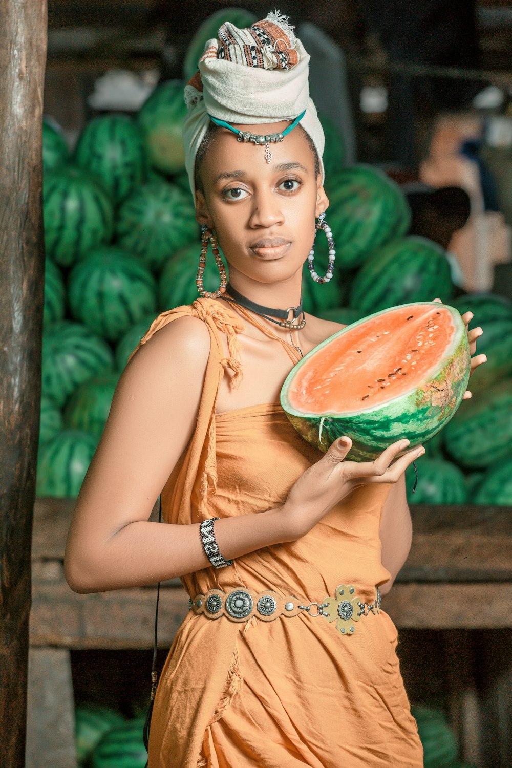 a woman holding a piece of watermelon in her hands