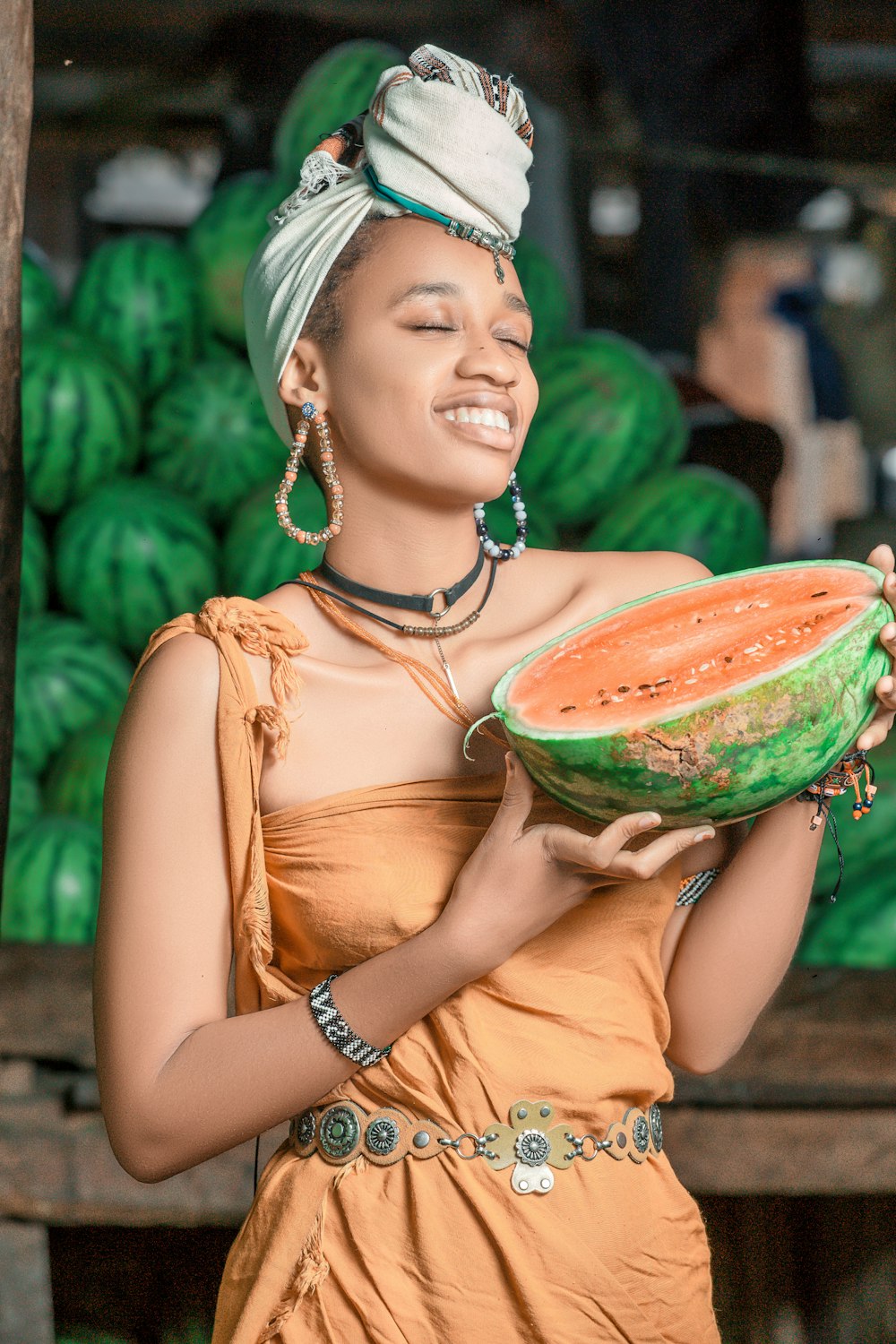 a woman holding a large piece of watermelon