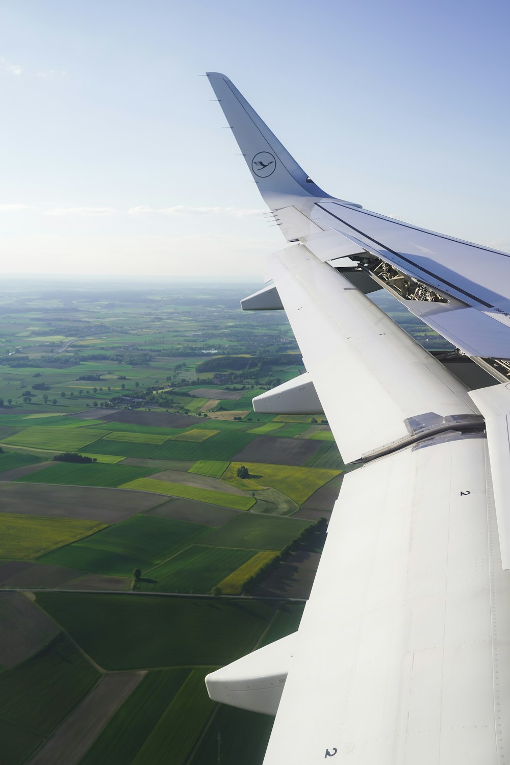 a view of the wing of an airplane in the sky