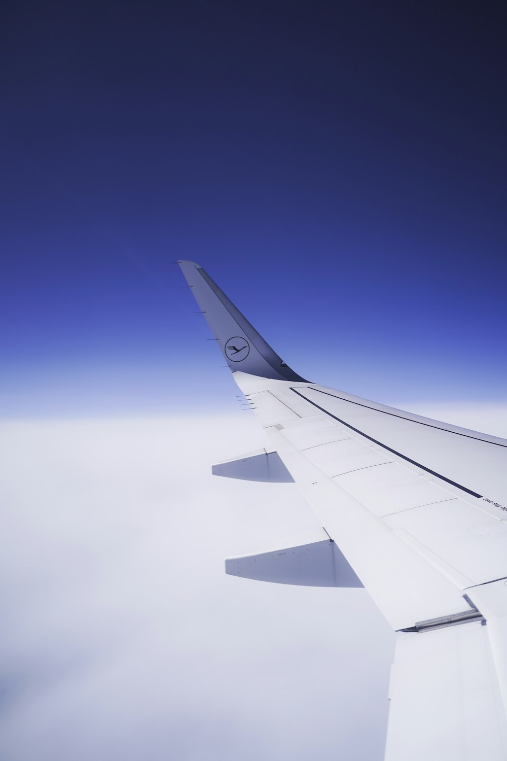 a view of the wing of an airplane in the sky