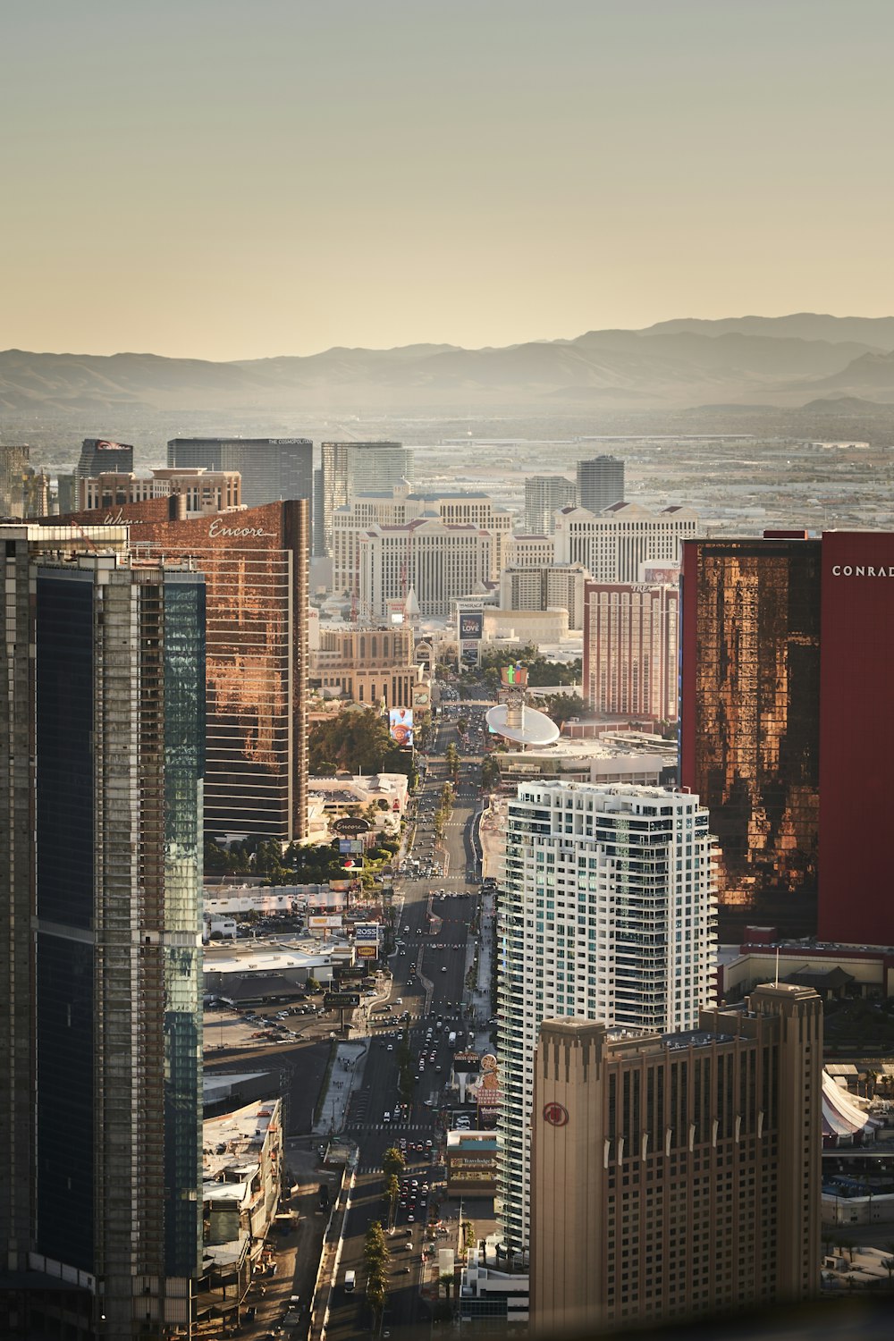 a city with tall buildings and mountains in the background