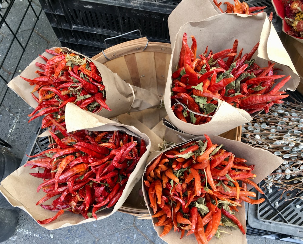 a group of baskets filled with lots of red peppers