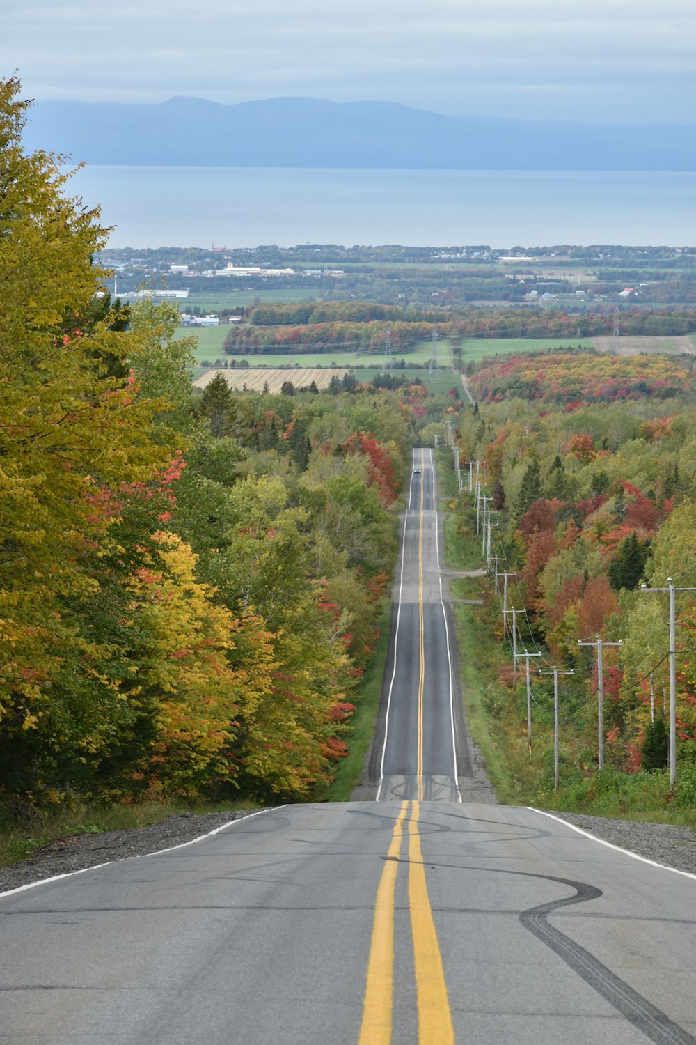 a long road with a yellow line in the middle of it