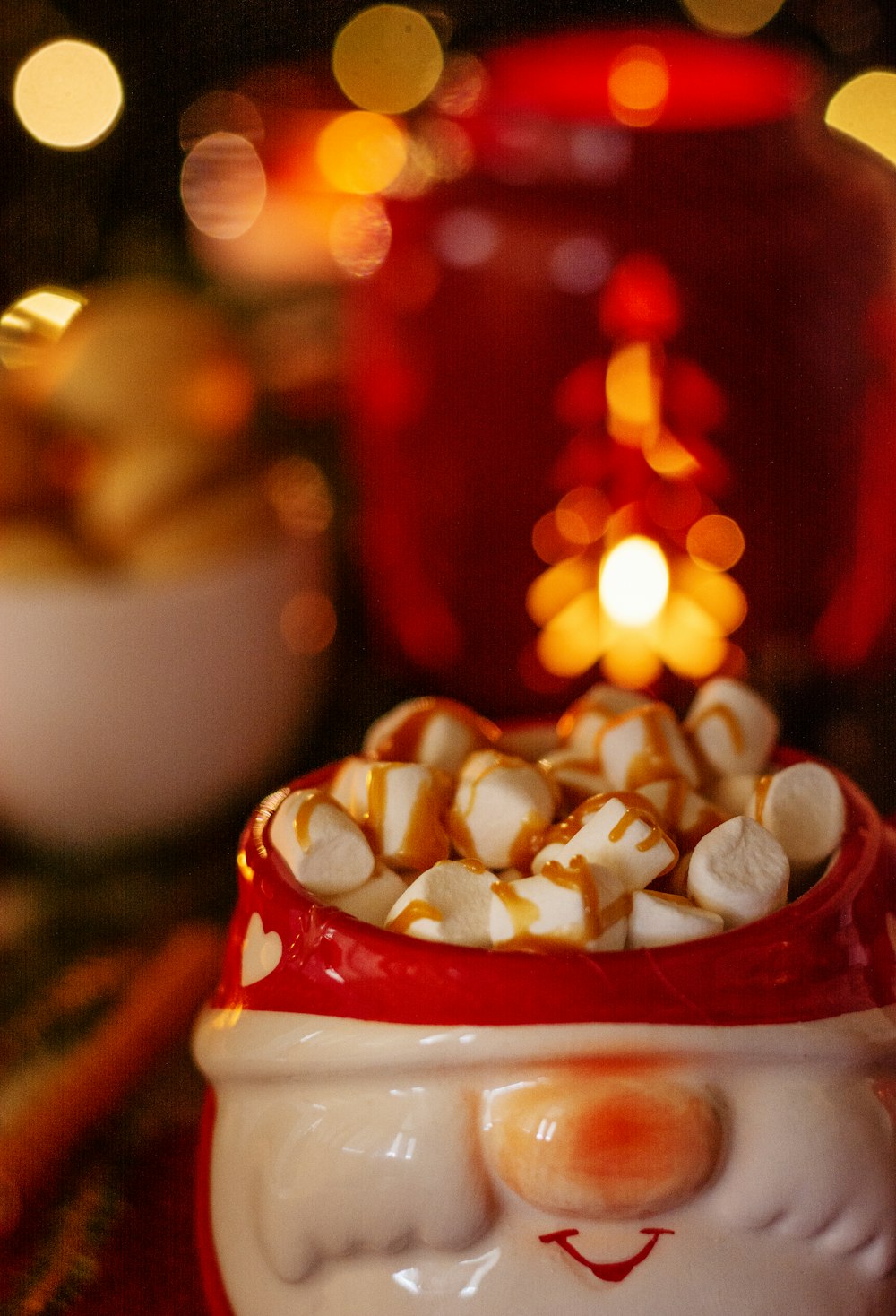 a mug filled with marshmallows sitting on top of a table