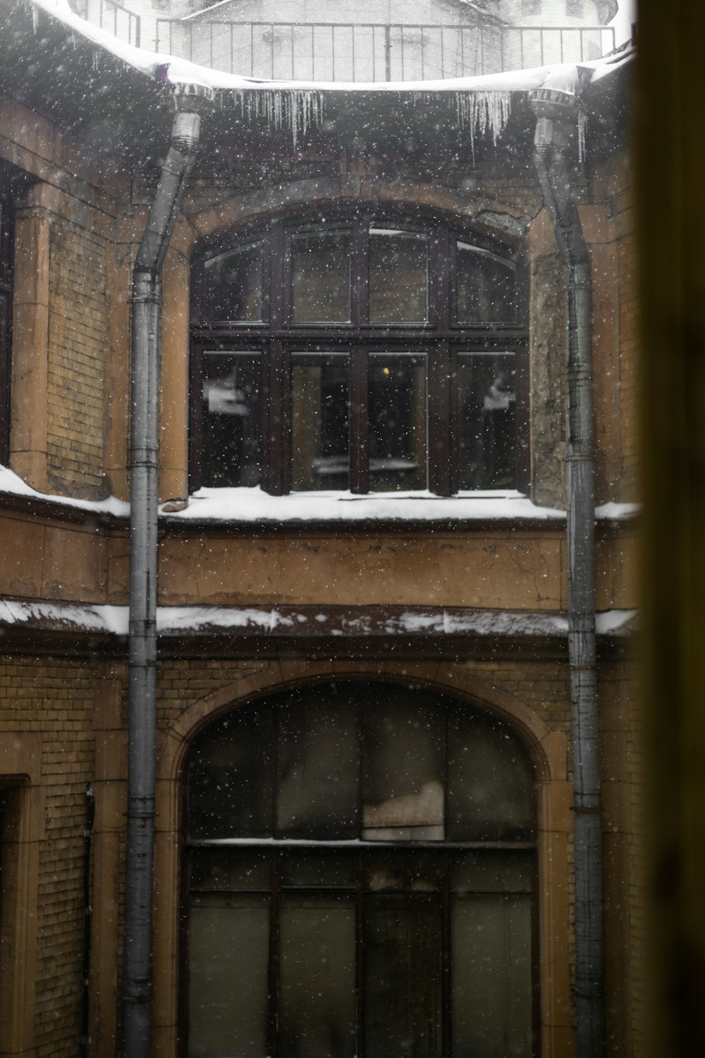 a building with snow on the roof and windows