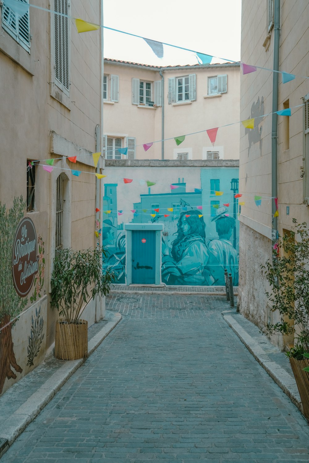 an alley way with a mural on the wall