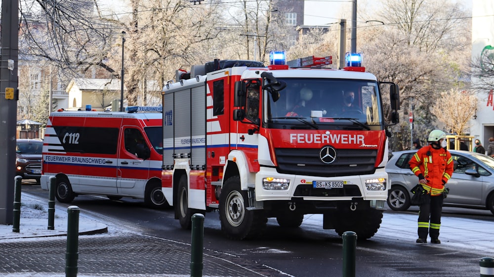 a red and white fire truck and a fireman