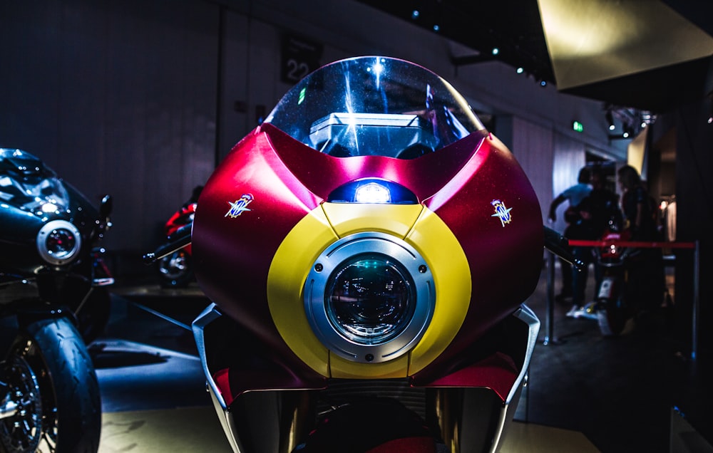 a red and yellow motorcycle is on display
