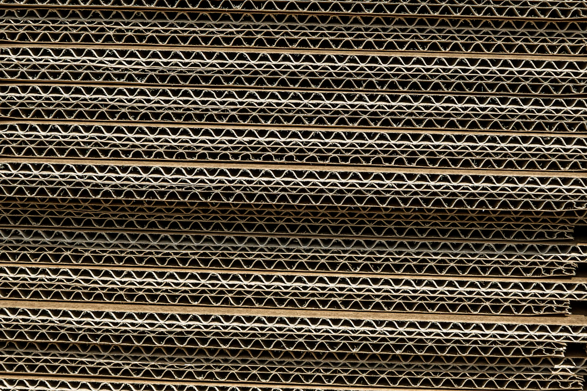 Stack of corrugated boxes of varying sizes in a warehouse ready for export