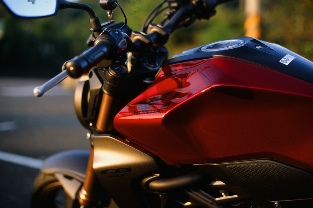 a red motorcycle parked on the side of the road