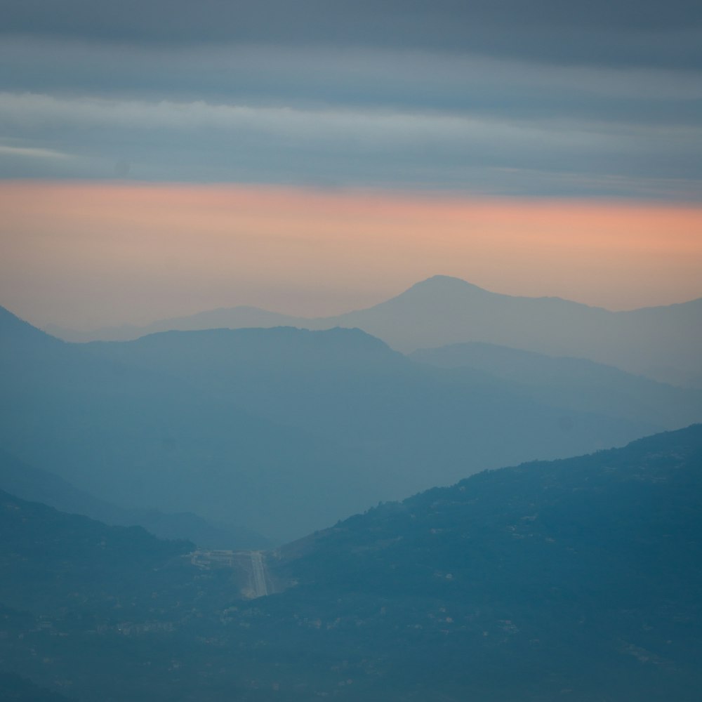 a view of a mountain range at sunset