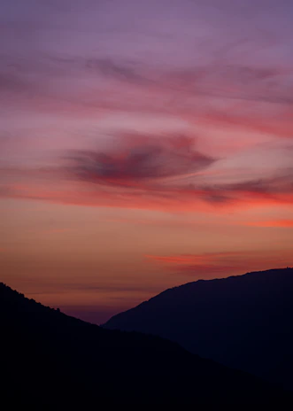 Beautiful sunset over the mountains of Hainan with soft pastel colors in the sky.
