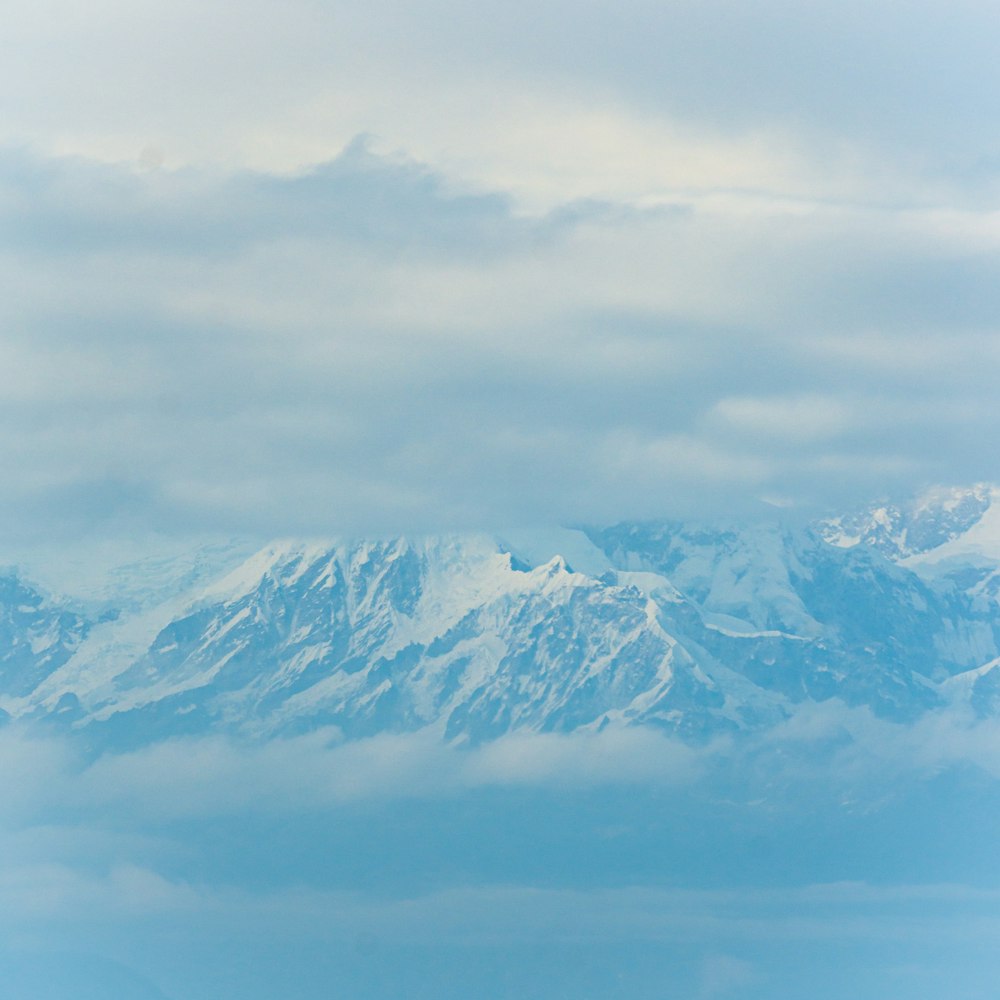 a view of a snowy mountain range from an airplane