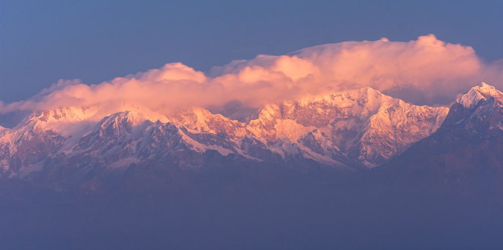 a view of a mountain range with clouds in the sky