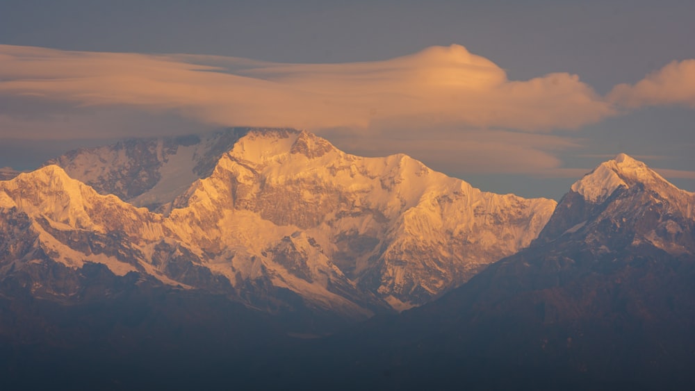 a view of a mountain range with clouds in the sky