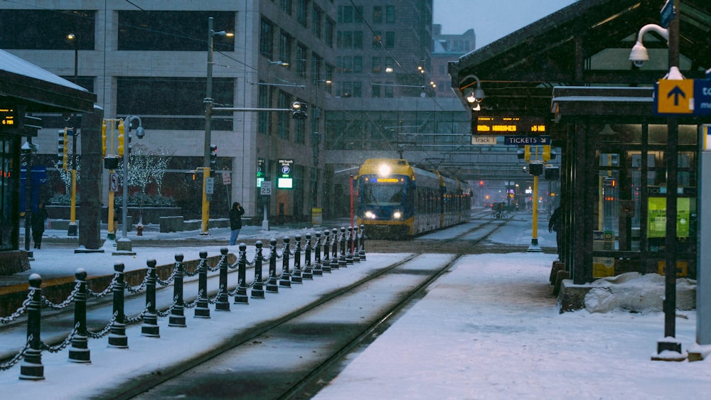 a train is coming down the tracks in the snow
