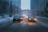 a couple of cars that are sitting in the snow