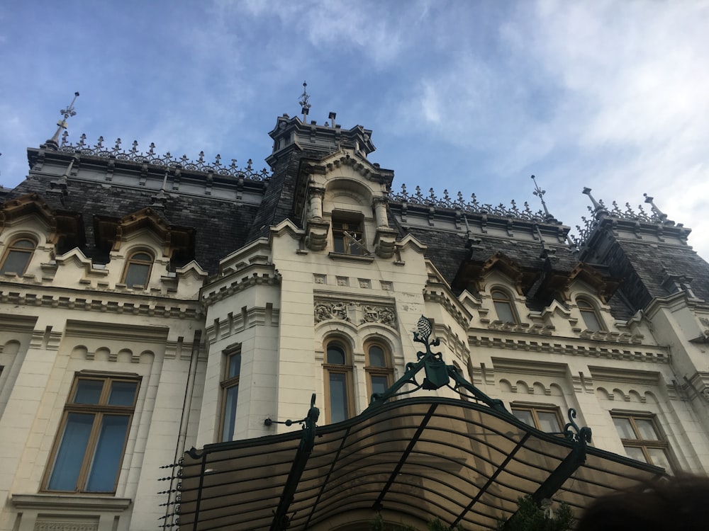 a large white building with a clock on it's side