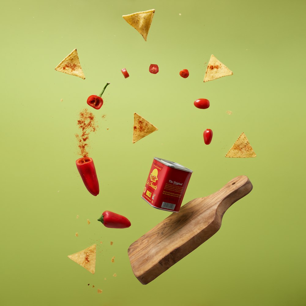a can of chili and a wooden board with chips falling out of it