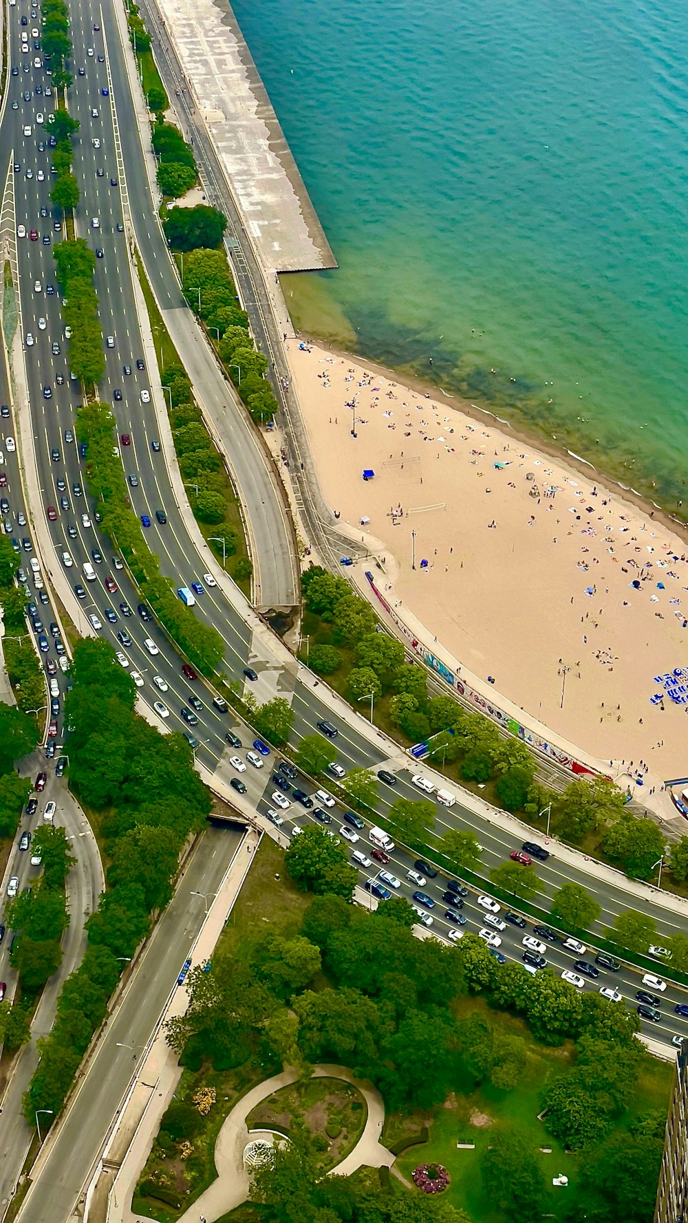 an aerial view of a beach and a highway