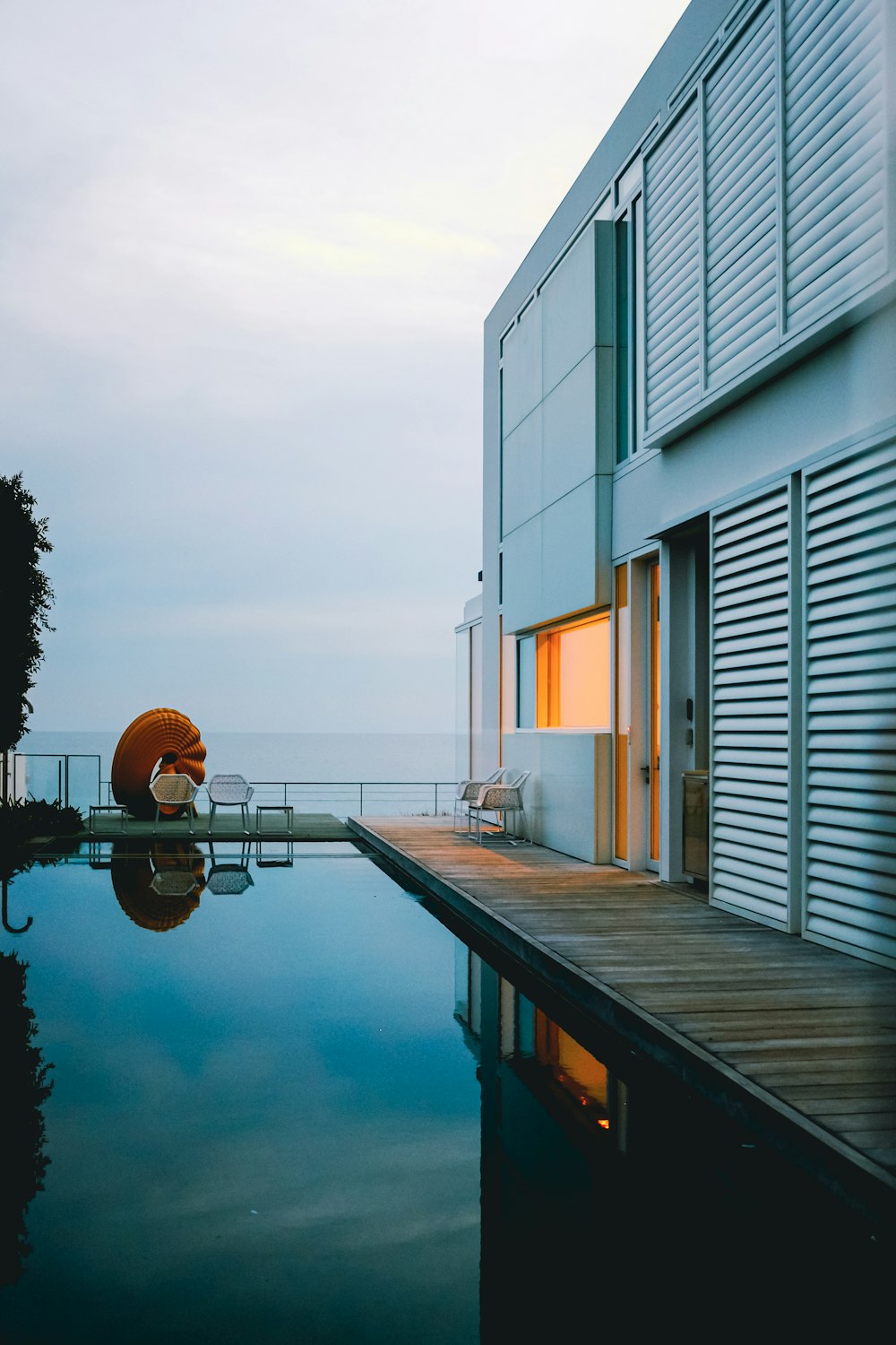 a house with a pool in front of it