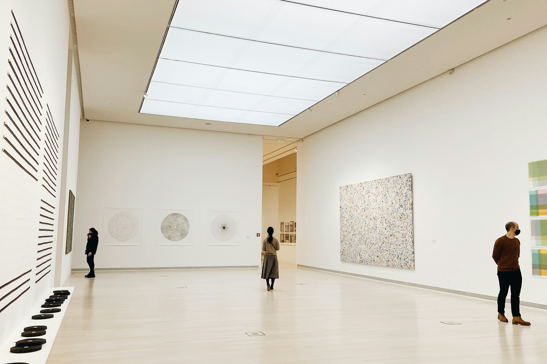 a group of people looking at art in a museum