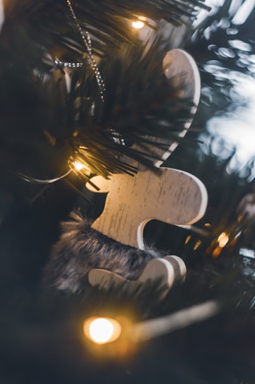 Close-up of a detailed laser-engraved wooden ornament glowing under soft light.